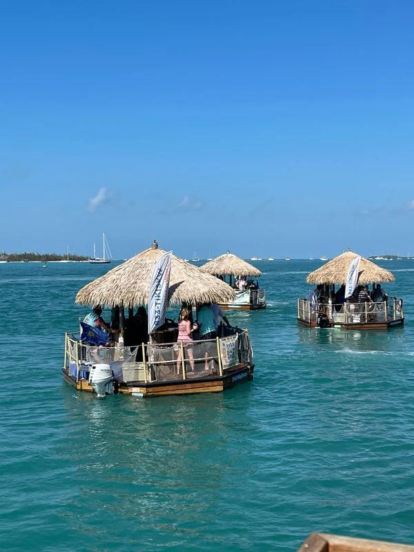 Two thatched tiki boats moored on turquoise water
